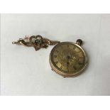 A 9ct gold lady's fob watch, together with a Victorian gold brooch,