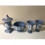 A tray containing four pieces of Wedgwood blue and white jasperware including a pair of vases