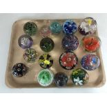 A tray of seventeen assorted glass paperweights