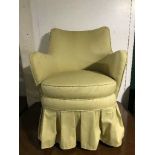 A mid 20th century armchair in gold fabric