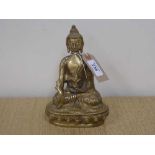 A brass figure of a Buddha