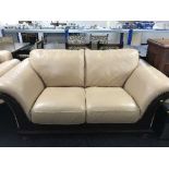 Three seater and two seater leather settees in wood frames