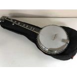 An Eagle four string banjo with carry bag