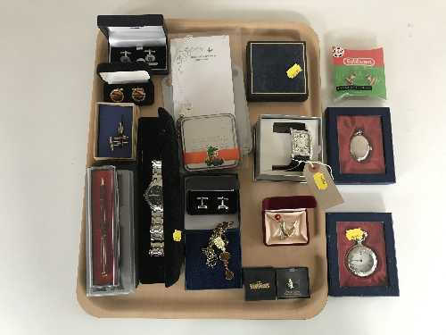 A tray of costume jewellery, pin badges, cuff links,