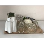 A tray containing vintage glass and pottery jelly molds, Royal Doulton pewter lidded jug,