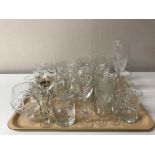 A large quantity of assorted drinking glasses, vinegar bottle,