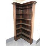 An antique mahogany corner bookcase