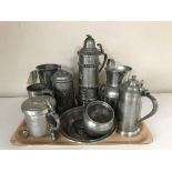 A tray of early 20th century pewter tankards, jugs,