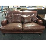 A two seater settee and armchair in maroon leather