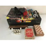 A box of vintage board games, Yamaha recorder, ice skates,