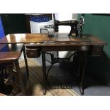 A Singer treadle machine in oak table