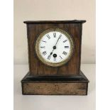 An antique mahogany and pine mantle clock with enamelled dial,