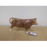 A Beswick figure - Limousin Cow, model 3075B, gloss, with Beswick Collector's Club stamp.