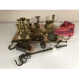 A tray of vintage balance scales, brass candlesticks,