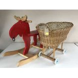 A child's rocking Moose toy and a wicker doll's pram