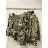 A very large quantity of British Army clothing, jackets, trousers, protective hard hats,