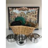 A large wicker basket of china, pans, neck cushion, two prints,
