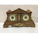 An antique oak bracket clock with gilt and enamelled dial, fitted with a barometer,