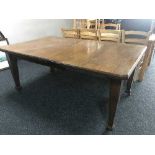 A late Victorian oak wind out table fitted two leaves