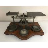 A set of antique postal scales with weights