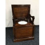 A Victorian mahogany commode with a ceramic liner