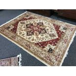 A Persian Heriz rug on beige ground, 230cm by 160cm.