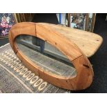 An oval pine coffee table and mirror