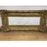 A gilt framed panel depicting figures