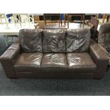 A brown leather two seater and matching three seater settee