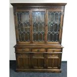 A carved oak triple door dresser