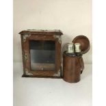 An early 20th century oak smoker's cabinet and three hip flasks in leather case