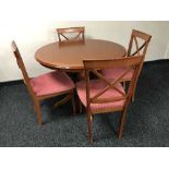 A circular dining table by Morris of Glasgow and four chairs