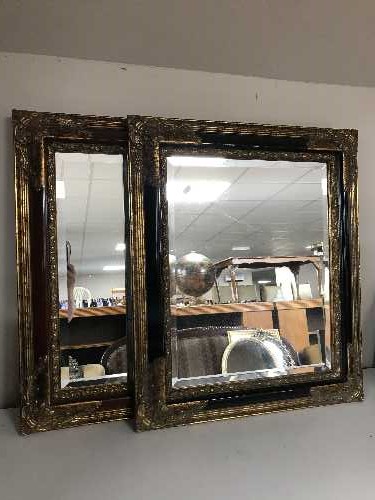 A black and gilt framed mirror and a red and gilt framed mirror (2)