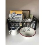 A basket of china, table linen, counter top Jubilee clothes clip stand,