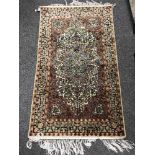 A Kashmir silk piled fringed rug