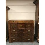 A mahogany campaign-style chest of six drawers around a central drawer, with brass fittings,