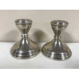 A pair of loaded silver dwarf candlesticks