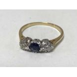 An 18ct gold three stone diamond and sapphire ring