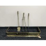 An early 20th century brass fire curb and companion set