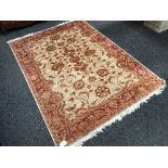 A fringed Persian Ziegler rug, on red ground, 230 cm x 160 cm.