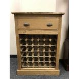 A reclaimed pine bottle rack fitted with a drawer, width 74 cm.