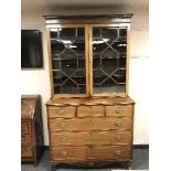 A George III style inlaid mahogany bookcase,