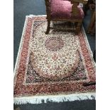 A fringed Persian Keshan rug, on red ground, 190 cm x 140 cm.