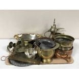 A tray of brass and copper ware, embossed copper plaque, candle snuffer, brass planters,