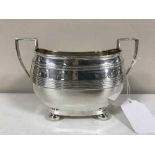 A sterling silver twin-handled sugar bowl,