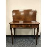 A 19th Century mahogany foldover top tea table, on tapered legs, width 90 cm.