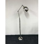 A chrome angle poise floor lamp