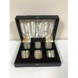 Six boxed silver napkin rings