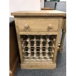 A reclaimed pine bottle rack, fitted with a drawer above, width 61 cm.