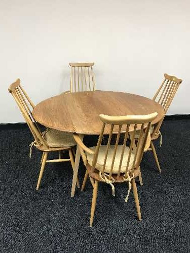 An Ercol elm drop leaf kitchen table and four chairs